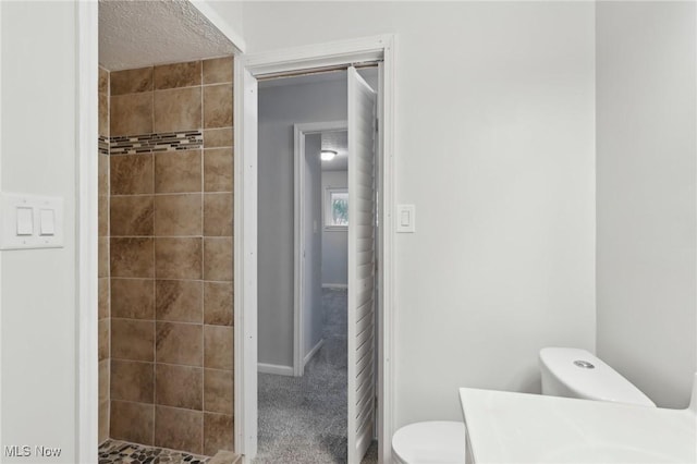 full bathroom featuring a shower stall, toilet, and vanity