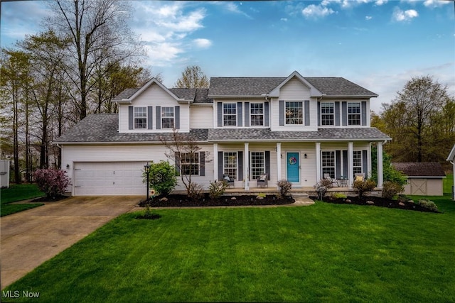 view of front of house featuring a storage unit, a porch, a front yard, an outdoor structure, and driveway