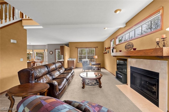 living area with carpet floors, baseboards, and a fireplace