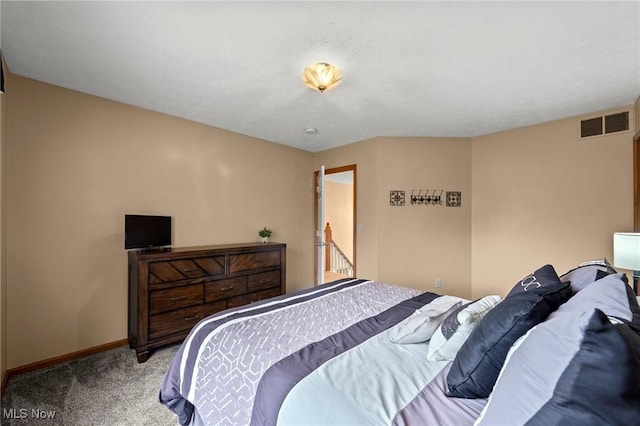 carpeted bedroom featuring baseboards and visible vents