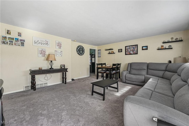 living room featuring carpet flooring and baseboards