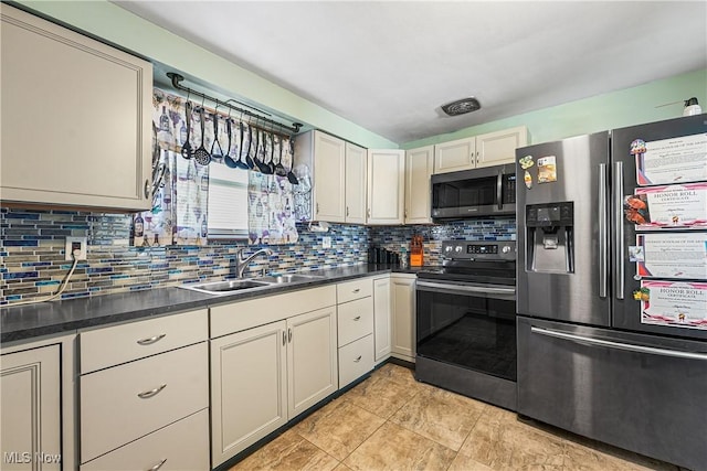 kitchen featuring decorative backsplash, stainless steel appliances, dark countertops, a sink, and light tile patterned flooring