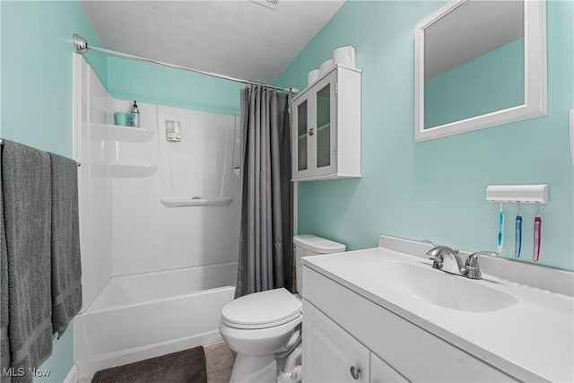 bathroom with tile patterned floors, shower / tub combo, vanity, and toilet