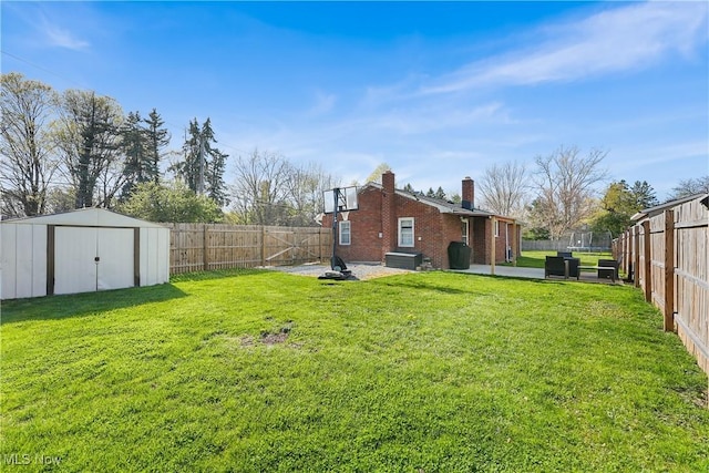 view of yard with an outdoor structure, a shed, a patio, and a fenced backyard