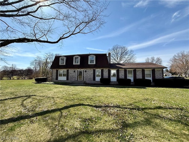 view of front of house with a front lawn and brick siding