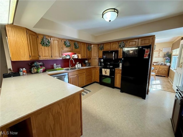 7455 Brushmore Ave NW, North Canton, OH 44720 - kitchen featuring black appliances, light countertops, brown cabinetry, and a raised ceiling