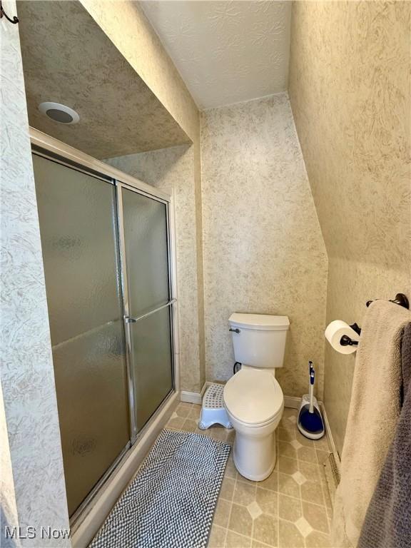 7455 Brushmore Ave NW, North Canton, OH 44720 - bathroom with a shower stall and tile patterned floors