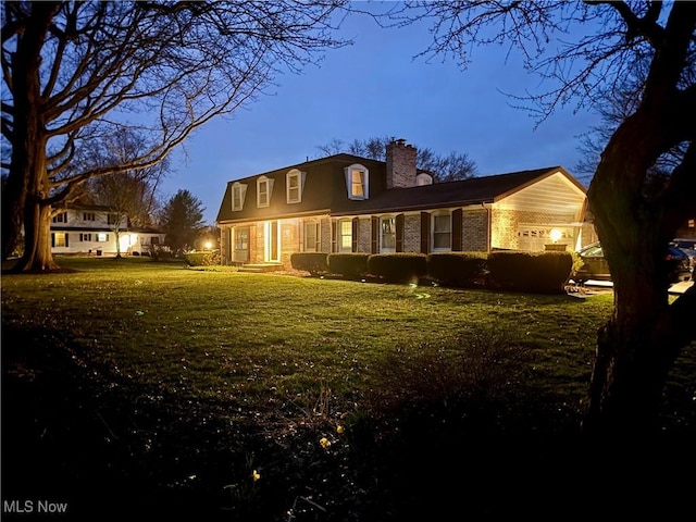7455 Brushmore Ave NW, North Canton, OH 44720 - back of property with a chimney, a garage, a yard, and brick siding