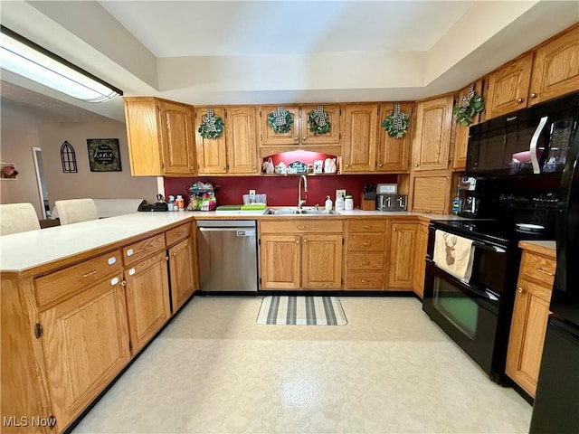 7455 Brushmore Ave NW, North Canton, OH 44720 - kitchen with black appliances, light countertops, a peninsula, and brown cabinets
