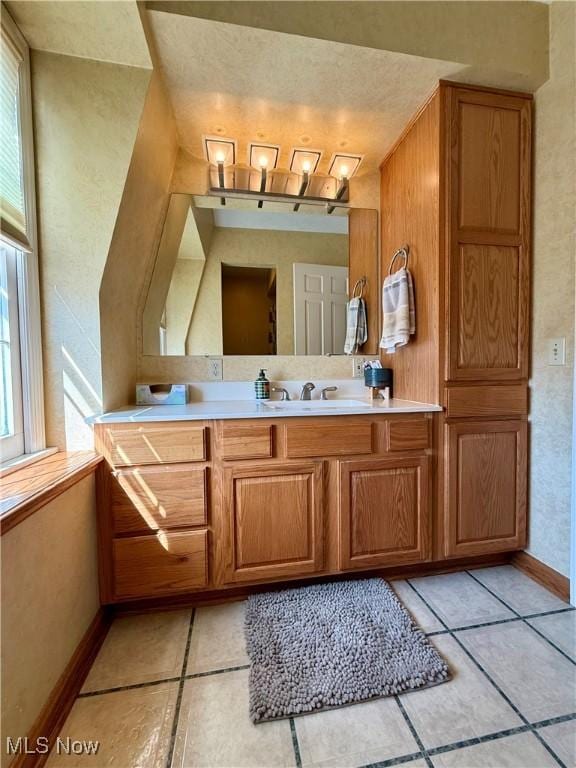 7455 Brushmore Ave NW, North Canton, OH 44720 - bathroom with vanity and tile patterned floors