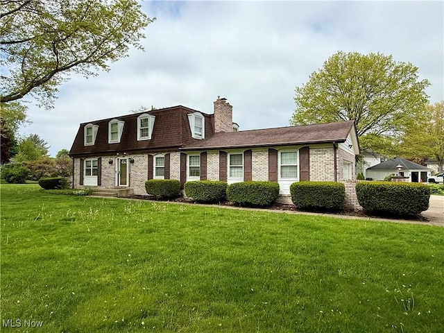 7455 Brushmore Ave NW, North Canton, OH 44720 - view of front of house featuring brick siding, a front yard, a chimney, and a shingled roof