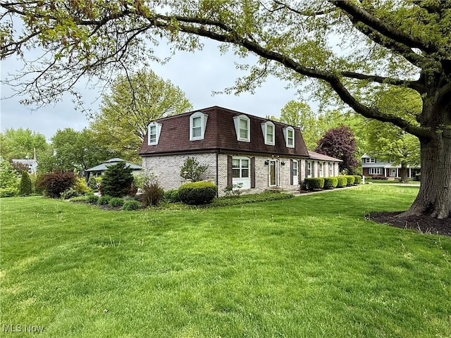 7455 Brushmore Ave NW, North Canton, OH 44720 - view of property exterior with mansard roof, a yard, and brick siding