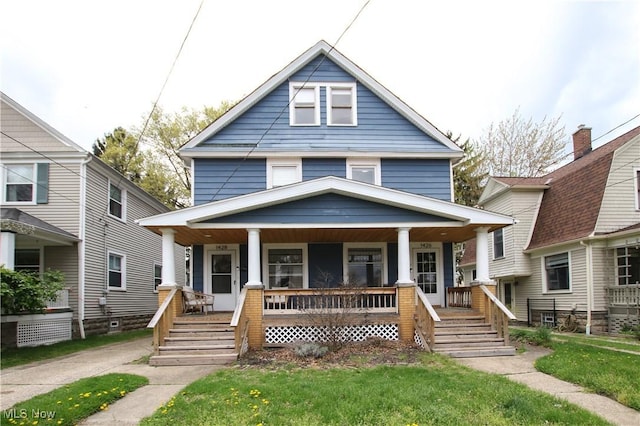 american foursquare style home with a porch