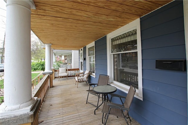 wooden terrace featuring covered porch