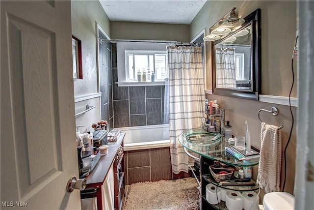 full bath featuring toilet, tiled shower / bath, and vanity