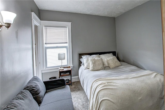 bedroom with carpet floors and baseboards