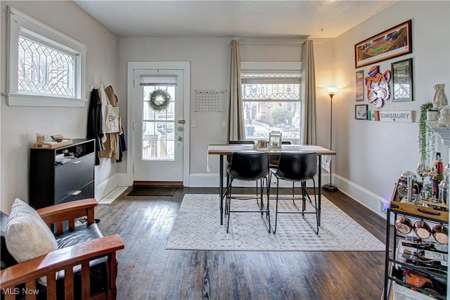 office area featuring dark wood-style flooring, a wealth of natural light, and baseboards