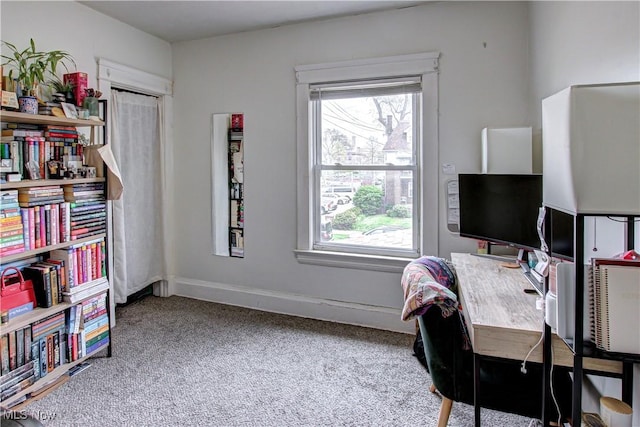 carpeted office featuring baseboards and plenty of natural light