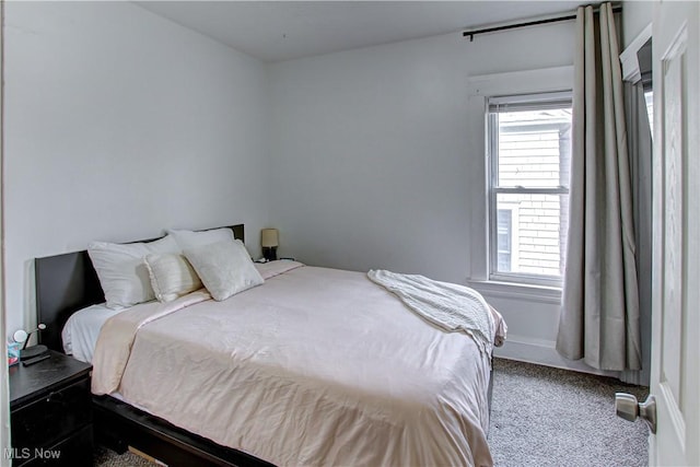 bedroom with carpet flooring and multiple windows