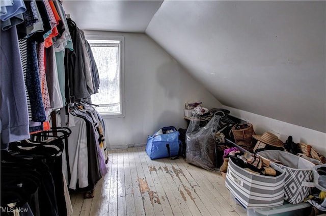 spacious closet featuring hardwood / wood-style floors and vaulted ceiling