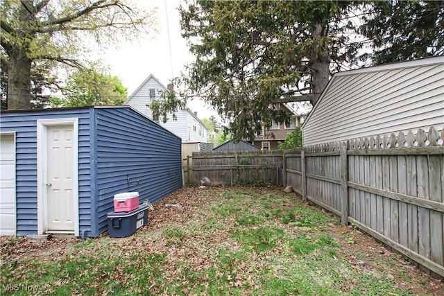 view of yard with a fenced backyard and an outdoor structure