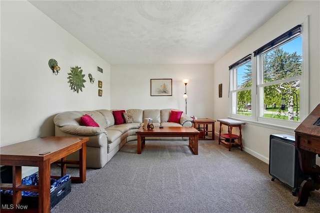 living room with visible vents, carpet flooring, and baseboards