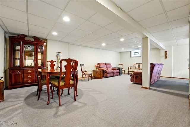 carpeted dining space with a drop ceiling and recessed lighting