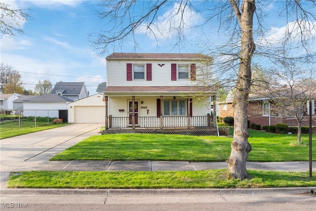 view of front of home featuring a garage, covered porch, and a front yard