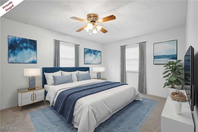 bedroom with carpet floors, baseboards, and a ceiling fan