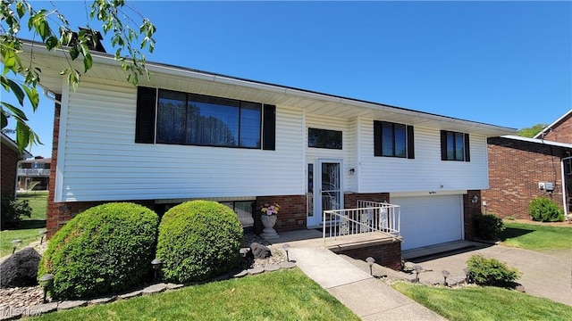 813 Brentwood Dr, Belpre, OH 45714 - raised ranch with brick siding, a garage, and concrete driveway