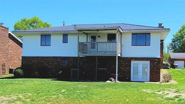 813 Brentwood Dr, Belpre, OH 45714 - rear view of house with metal roof, french doors, brick siding, a balcony, and a yard