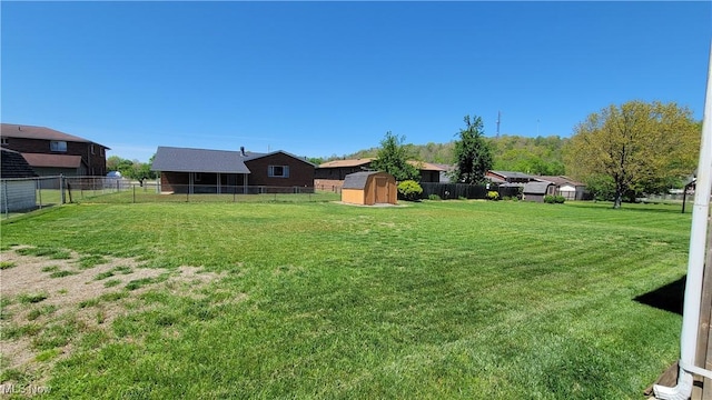 813 Brentwood Dr, Belpre, OH 45714 - view of yard with an outbuilding, a fenced backyard, and a storage unit