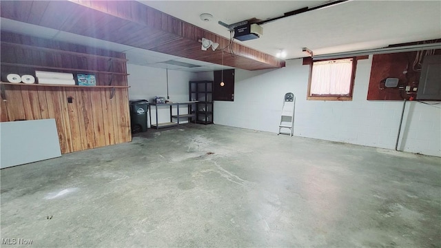 813 Brentwood Dr, Belpre, OH 45714 - garage featuring a garage door opener, electric panel, and concrete block wall