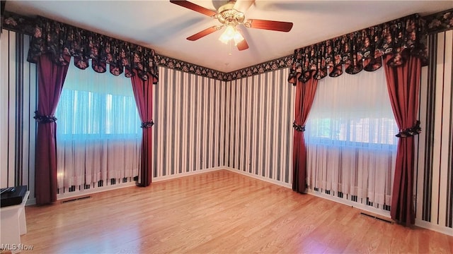 813 Brentwood Dr, Belpre, OH 45714 - unfurnished room with ceiling fan, visible vents, a wealth of natural light, and wood finished floors