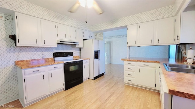 813 Brentwood Dr, Belpre, OH 45714 - kitchen with black electric range, white refrigerator with ice dispenser, a sink, under cabinet range hood, and wallpapered walls