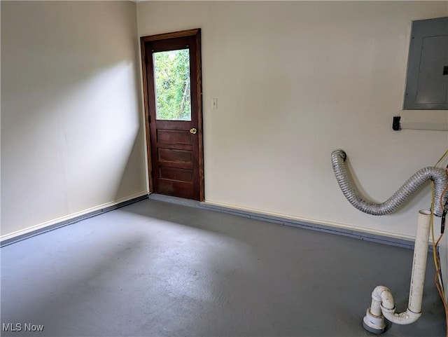 interior space featuring finished concrete flooring and electric panel