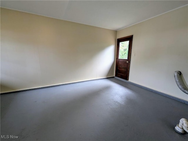unfurnished room featuring finished concrete floors