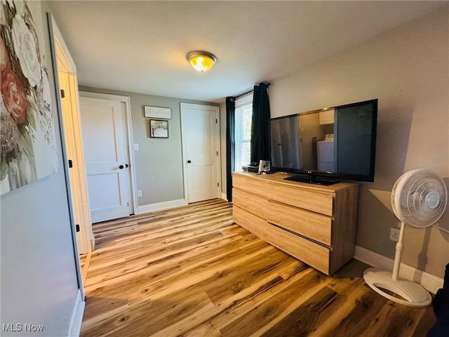 bedroom with wood finished floors and baseboards