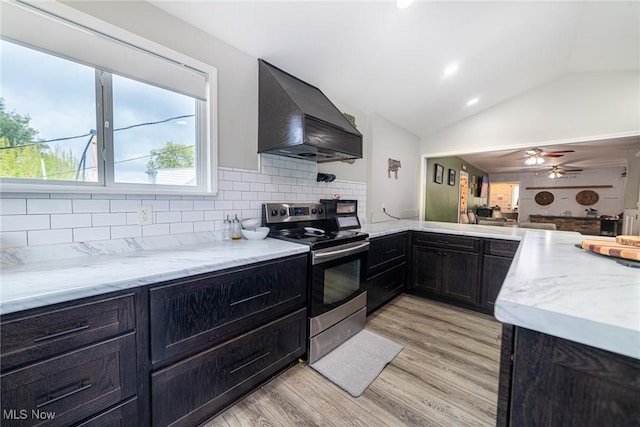 1741 Cambridge Rd, Coshocton, OH 43812 - kitchen with light wood-style floors, stainless steel electric range, custom range hood, backsplash, and lofted ceiling