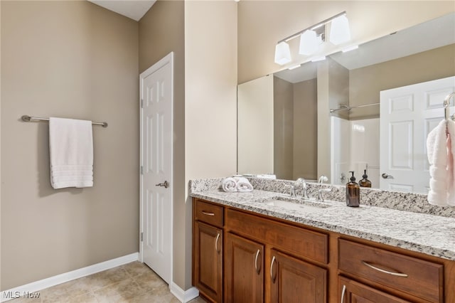 full bathroom featuring tile patterned flooring, vanity, and baseboards