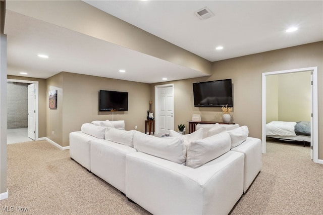 carpeted living area with baseboards, recessed lighting, and visible vents