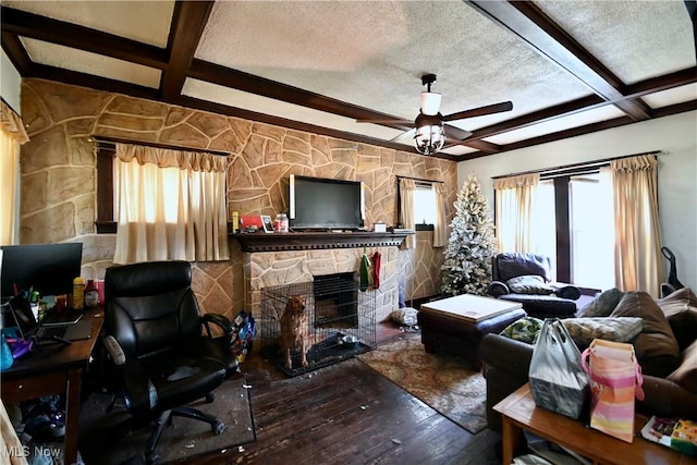 living room featuring hardwood / wood-style floors, a ceiling fan, coffered ceiling, and beamed ceiling