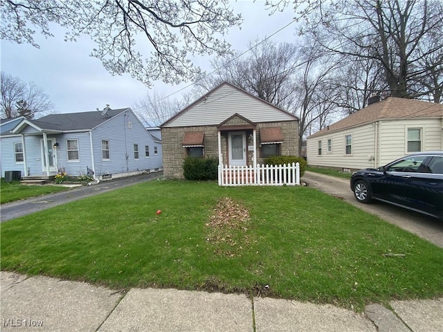 bungalow-style house featuring cooling unit, a front lawn, and stone siding