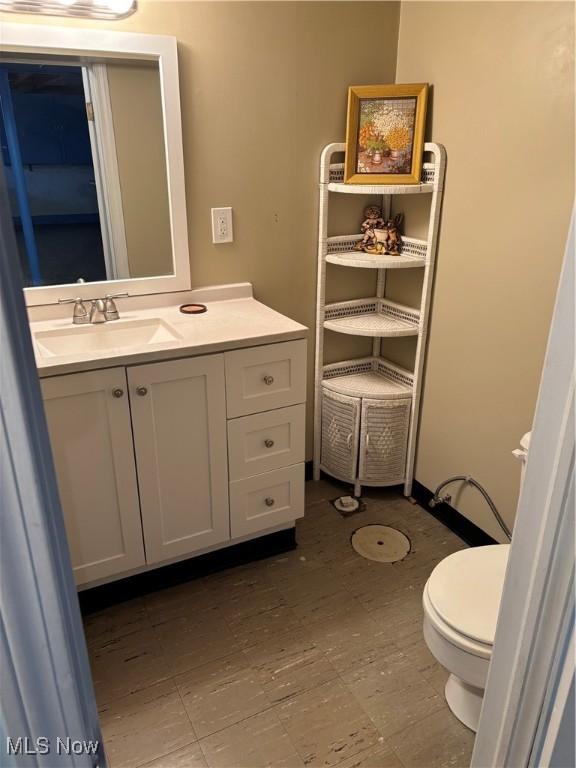 bathroom featuring vanity and toilet