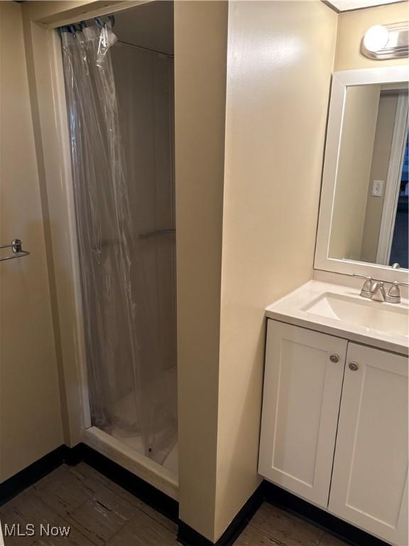 full bath featuring a shower stall and vanity