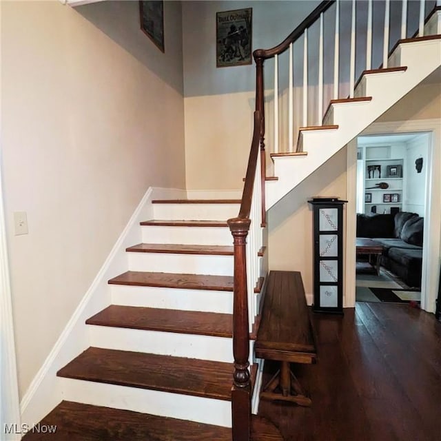 557 Cambridge Rd, Coshocton, OH 43812 - staircase with a towering ceiling, wood finished floors, and baseboards