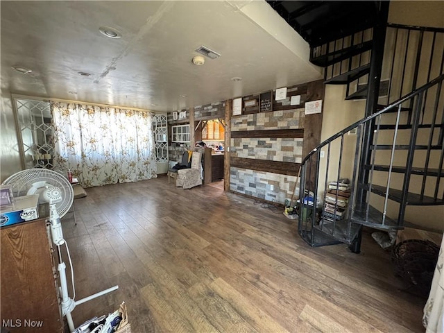 interior space with visible vents, stairway, and hardwood / wood-style flooring