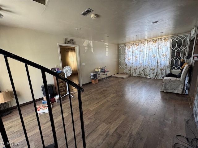 interior space with visible vents, baseboards, and wood-type flooring