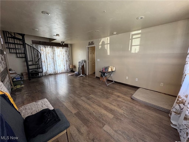 unfurnished room with baseboards, stairway, wood finished floors, and recessed lighting