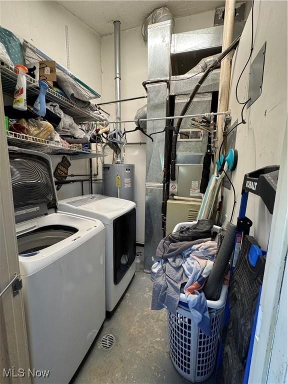 laundry room featuring electric water heater, separate washer and dryer, and laundry area